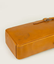 Load image into Gallery viewer, GUT OGGAU x SAGAN Vienna bag red I view from top I showing the bag lying on the back, showing belt detail and Gut Oggau iconic Theodora embossing I white background