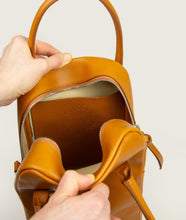 Load image into Gallery viewer, GUT OGGAU x SAGAN Vienna bag red I red I inside view I showing open inside leather pocket with embossing "Gut Oggau x SAGAN Vienna" I white background