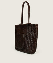 Load image into Gallery viewer, Woven I Pazar Book Tote Handwoven I brown I from aside I showing the iconic SAGAN closure strap and the front Book pocket I white background