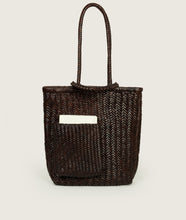 Load image into Gallery viewer, Woven I Pazar Book Tote Handwoven I brown I front view I showing the iconic SAGAN closure strap and the front Book pocket I white background