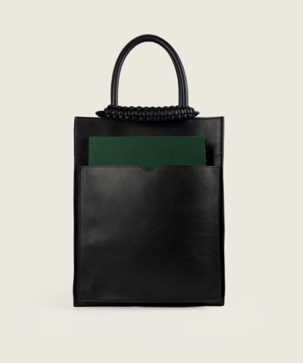 Pazar Magazine Tote Black I front view I showing the magazine pocket, the magazine and the signature braided handle I white background