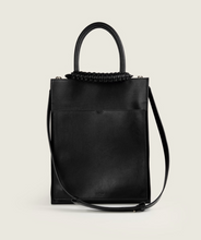 Load image into Gallery viewer, Pazar Magazine Tote Black I front view I showing the magazine pocket, the signature braided handle and also the shoulder strap I white background