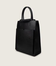 Load image into Gallery viewer, Pazar Magazine Tote Black I side view I showing the magazine pocket and the signature braided handle I white background