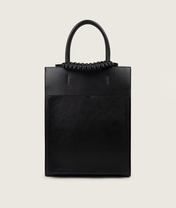 Pazar Magazine Tote Black I front view I showing the magazine pocket and the signature braided handle I white background