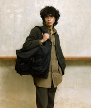 Load image into Gallery viewer, Nylon I Messenger bag XL Black recycled nylon I black I front view I man is wearing the bag in front of his body in SAGAN Vienna Shop