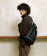 Load image into Gallery viewer, Nylon I more bag nylon black I black I side view I man wearing the bag crossbody at SAGAN Vienna Shop