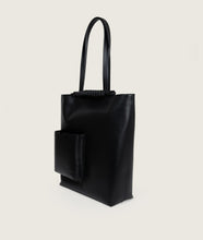 Load image into Gallery viewer, Pazar I Pazar Book Tote Black I side view I showing iconic closure system of SAGAN and the outside book pocket I white background