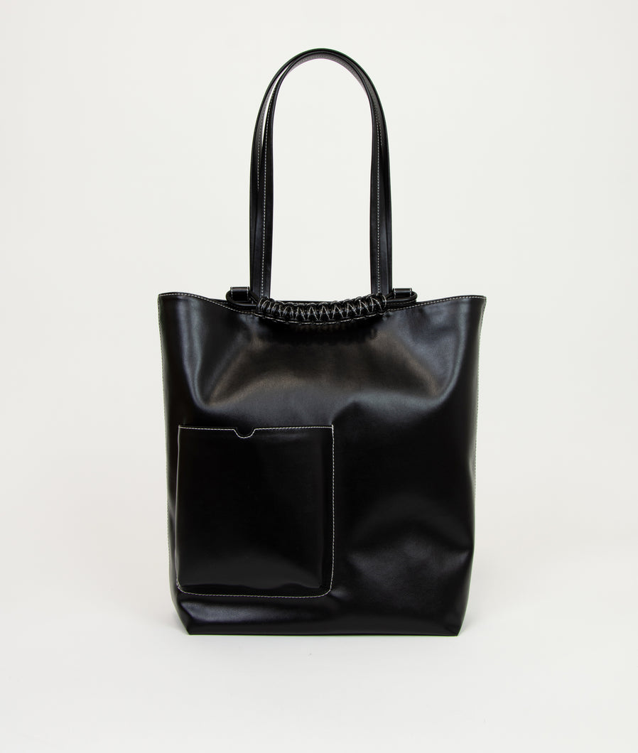 Pazar I Pazar Book Tote Grape Leather I Black with white Stitching I showing the iconic closure system and the outside book pocket I white background