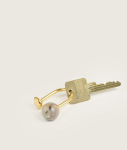 Accessories I Carl Auböck x SAGAN Vienna Stone Keychain Pluto with a Key I white background