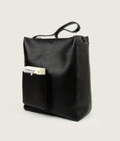 Load image into Gallery viewer, Watoji I Nasch Bag L I black I from aside, open outside pocket with the book "The Beauty of Everyday Things, white japanese stitch detail I white background