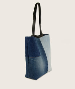 Sideview of Pazar Tote Denim bag from re-used denim, sustainable, vegan Italian grape leather. jeans comes in slightly different shades, hand braided signature leather handle.
