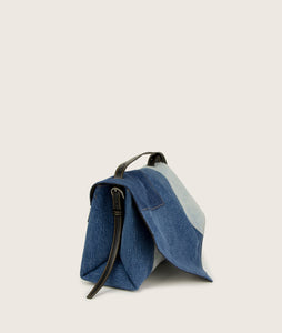 Side view Scarf Crossbody size M, re-used denim, sustainable, vegan Italian grape leather. Jeans comes in different shades, every piece is unique. Inspired by a draped scarf.